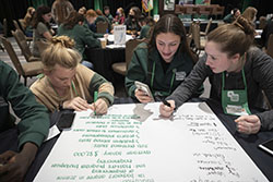 Volunteers surrounding a poster board