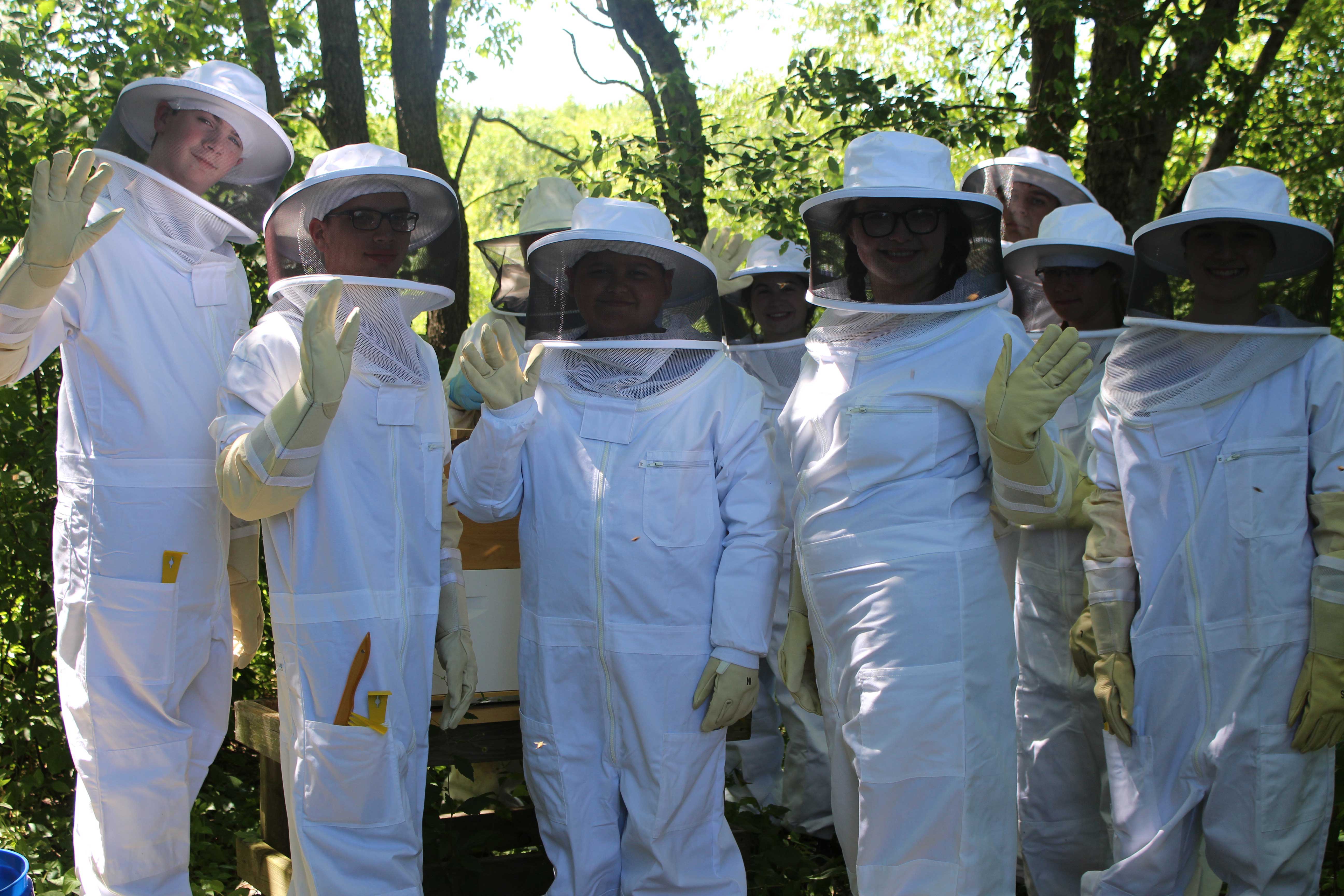 Children in beekeeper suits