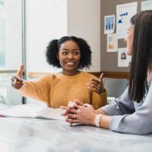 youth in a sweater speaking to an adult