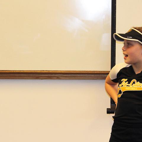 2 girls speaking in front of class