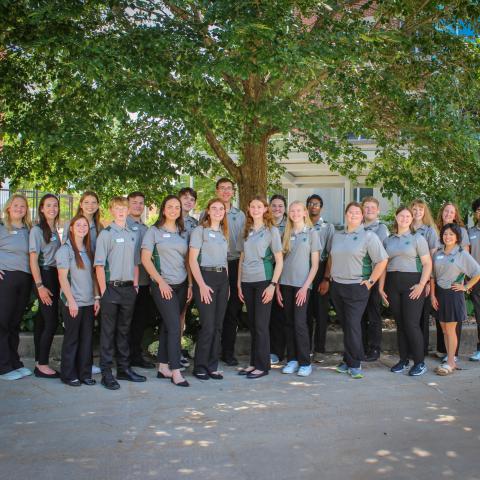 Youth Leadership Team posed in front of a tree