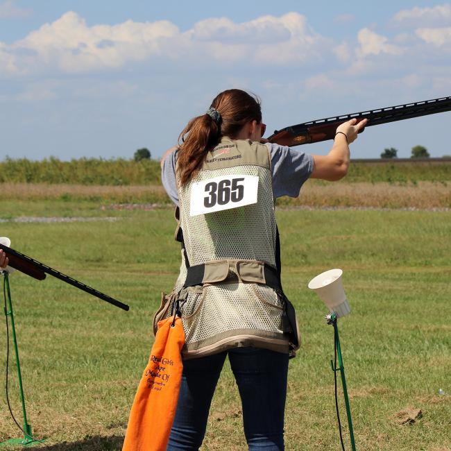 woman shooting shotgun in sporting event