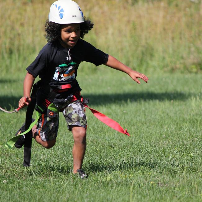 child running after zip line