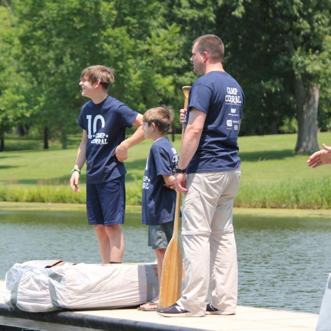 family on dock with homemade boat