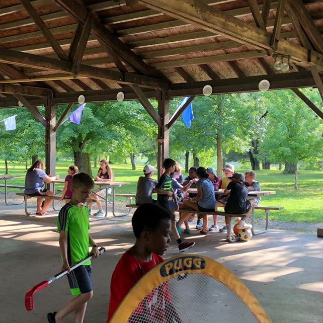 camp pavilion with picnic tables