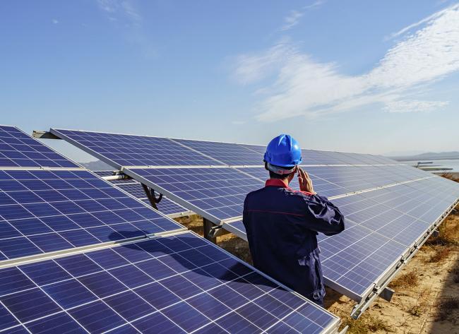 Man checking solar panels