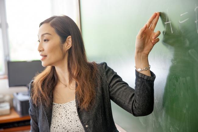 Teacher in front of chalkboard