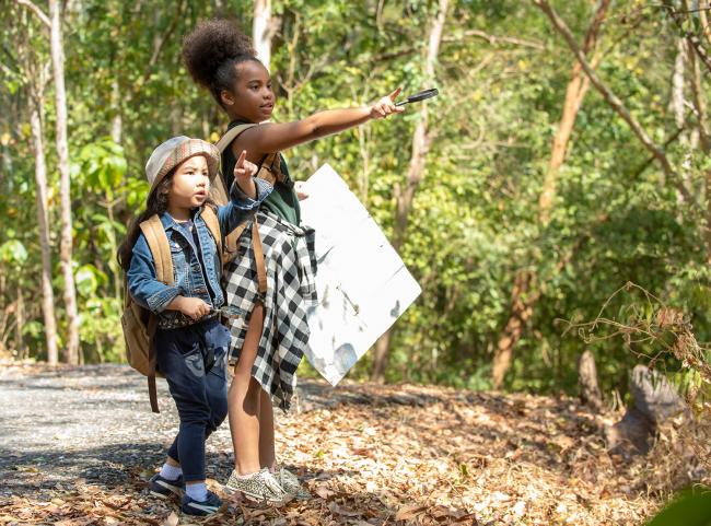 girls in the woods with map