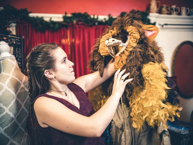 woman working on a costume