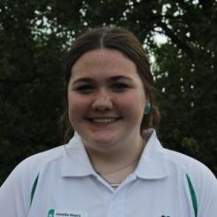 Girl with dark hair in white polo shirt