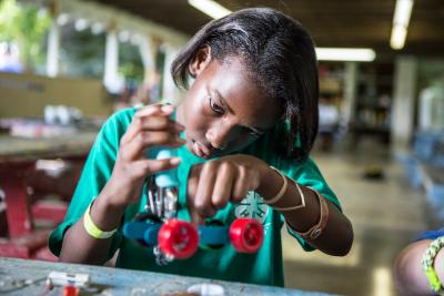 Girl building robotic car